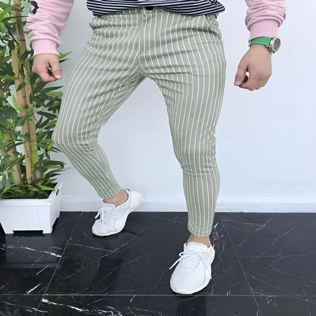 Man wearing slim-fit plaid casual trousers with a straight leg and micro-elastic fabric.