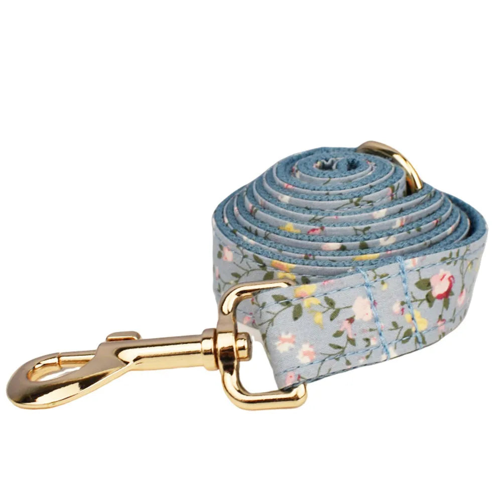 Blue floral polyester cotton dog collar set with matching leash, bow, vest, and poop bag accessories