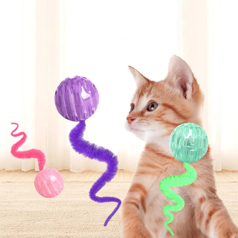 Interactive cat ball toy with plush tail in green, pink, and purple on white background
