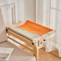 Wooden cat hanging bed hammock in a style style, mounted on a balcony railing for a cat to rest on.