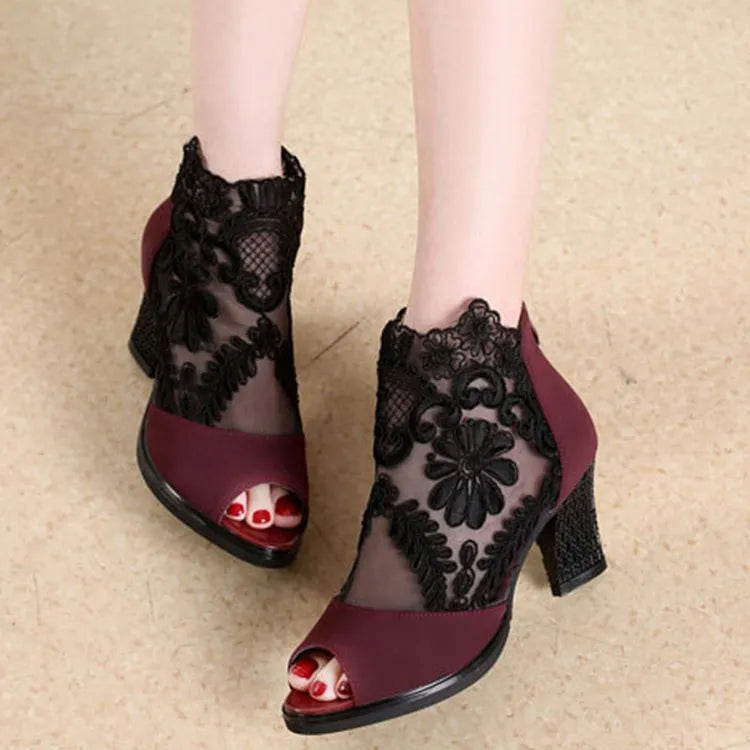Black women's lace-up gladiator sandals with a square heel and zip fastener.