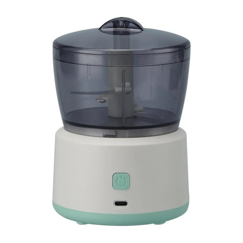 Mini meat grinder with transparent cup body, stainless steel blade, and USB rechargeable port in white colour