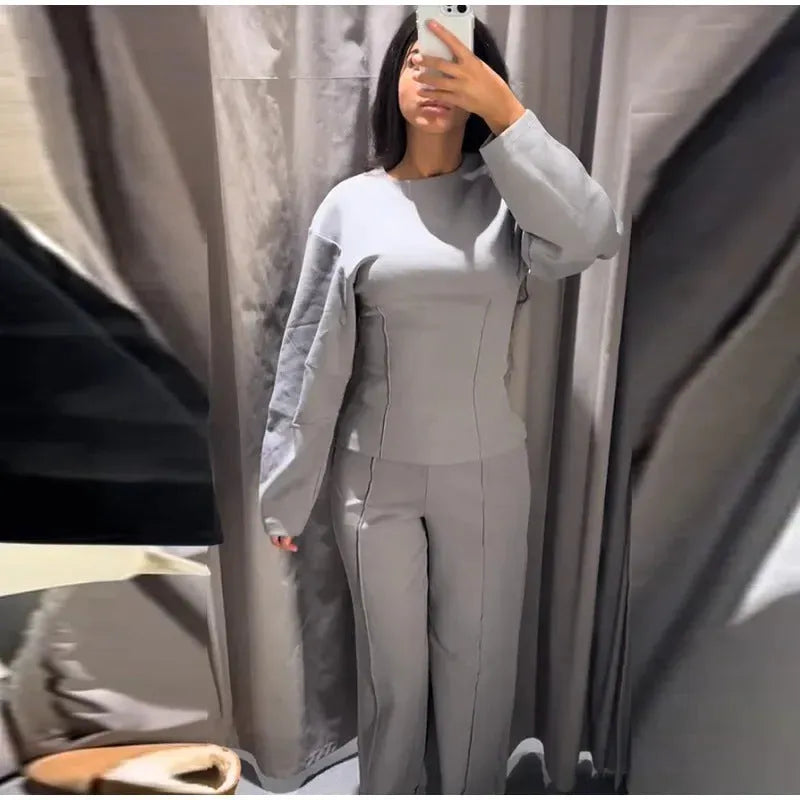 Women's black polyester fleece two-piece suit with long sleeve top and wide-leg trousers