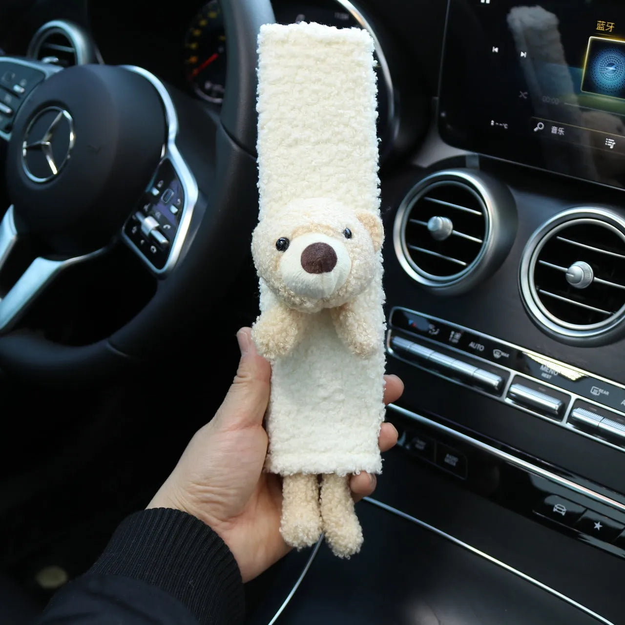 Soft plush car seatbelt shoulder protector with cartoon bear and rabbit designs made from lamb wool.