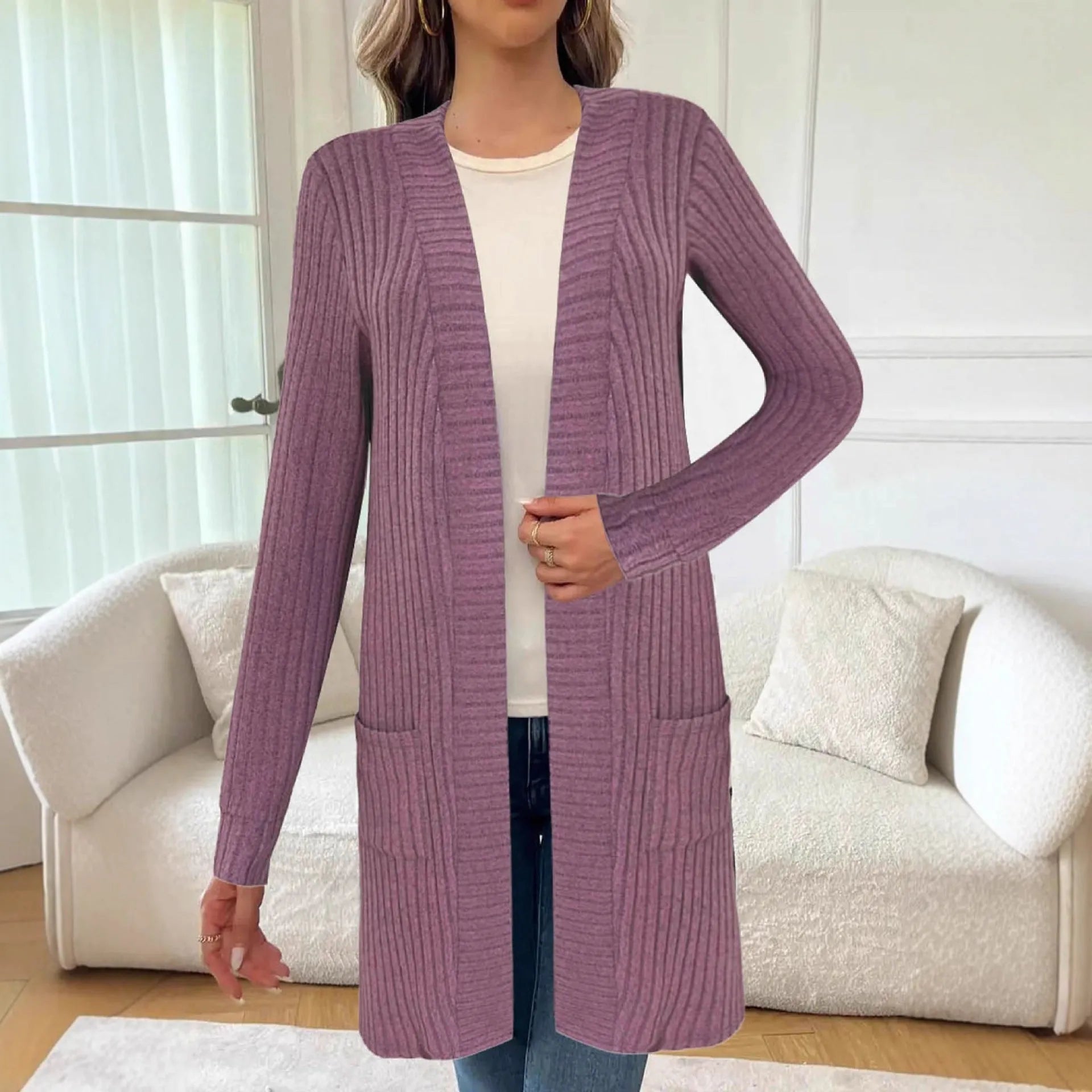 Long sleeve loose grey knitted cardigan jacket with pockets on a hanger