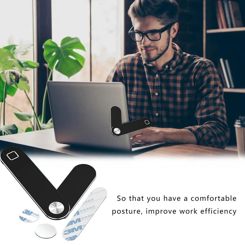 Black aluminium laptop phone holder with magnetic mount attached to laptop side