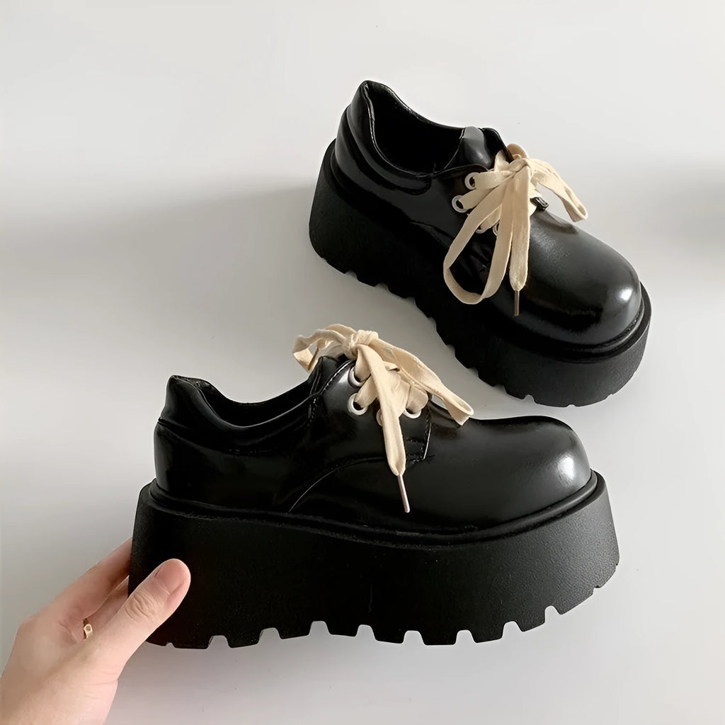 Women's matte black chunky heel lace-up shoes with a round toe and thick rubber sole.