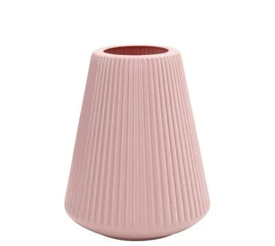 Melamine plastic decorative vase in blue colour on desktop with floral arrangement