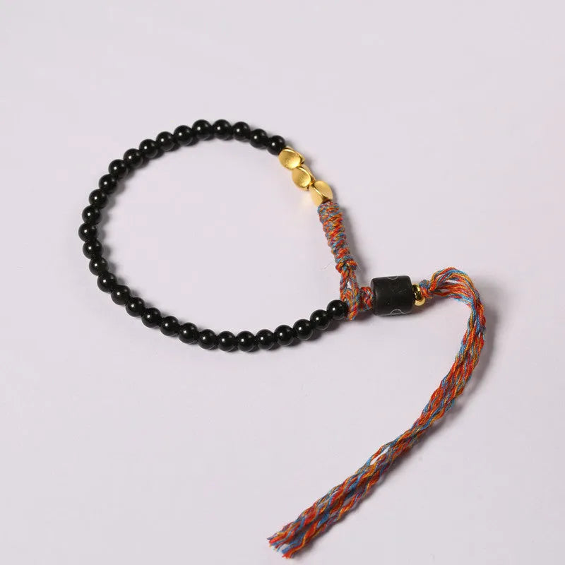 Hand-woven obsidian carrying strap bracelet showing 4mm width and adjustable length