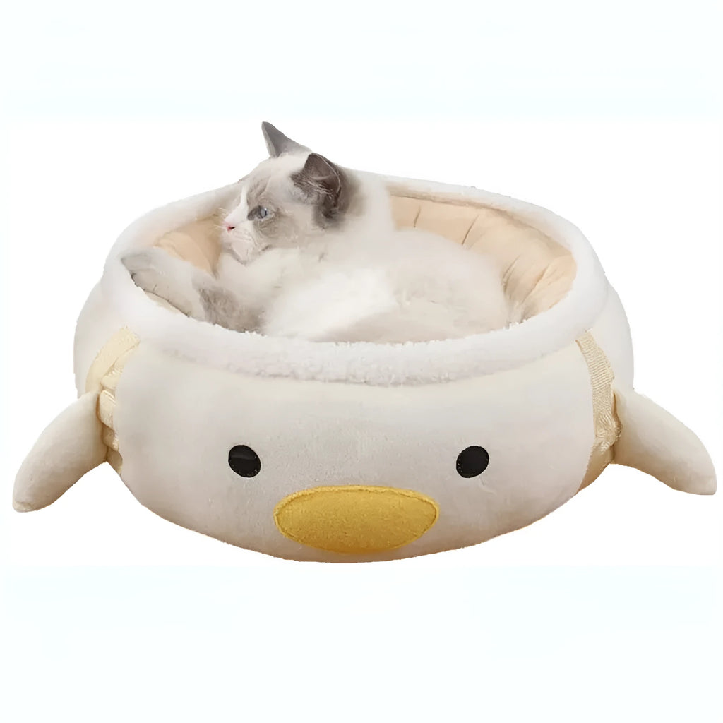 Green dinosaur and chick shaped cat bed shown both as a flat sofa and hanging as a hammock.