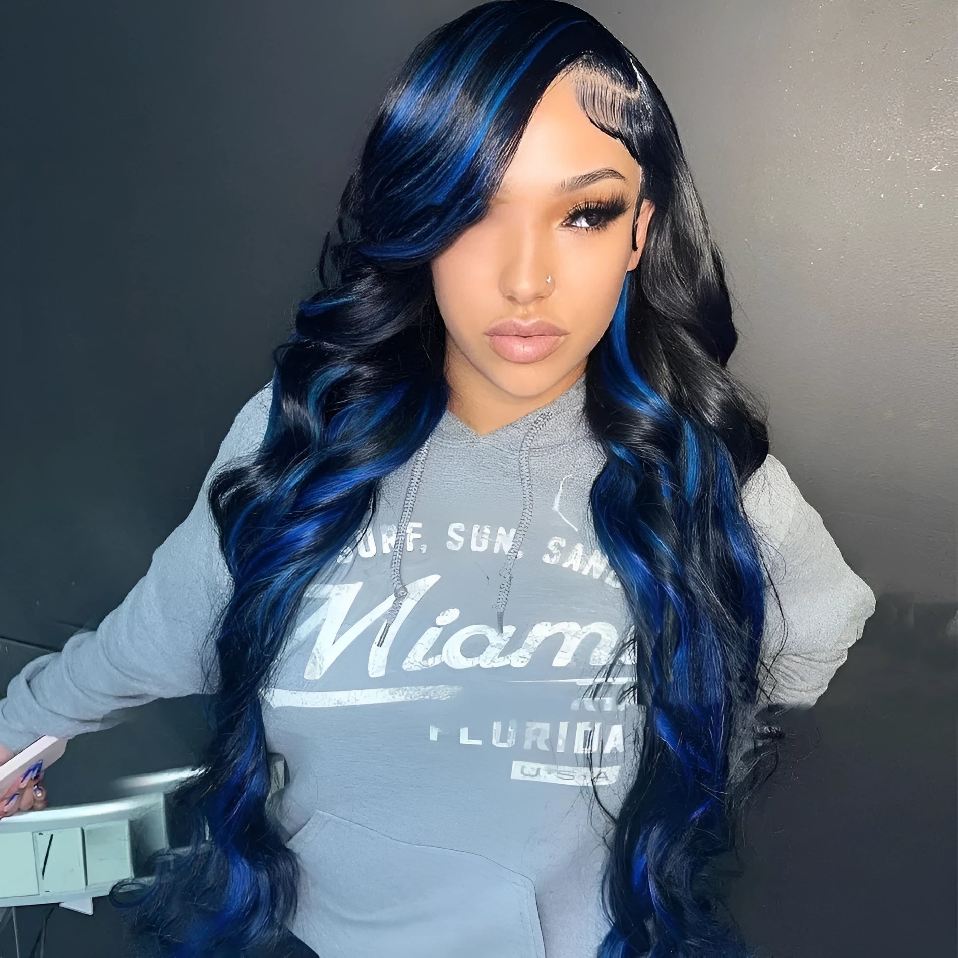 A woman wearing a real human hair lace front headgear with a 4x4 lace construction and long, styled hair.