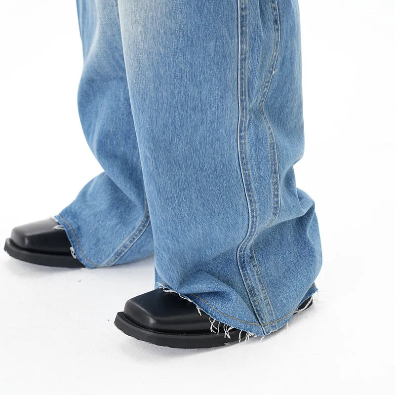 Light blue vintage washed wide leg machete jeans with zip fly on a model