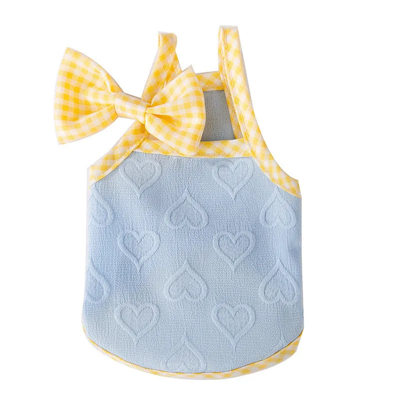 Small dog wearing elastic vest with bow suspenders and heart texture
