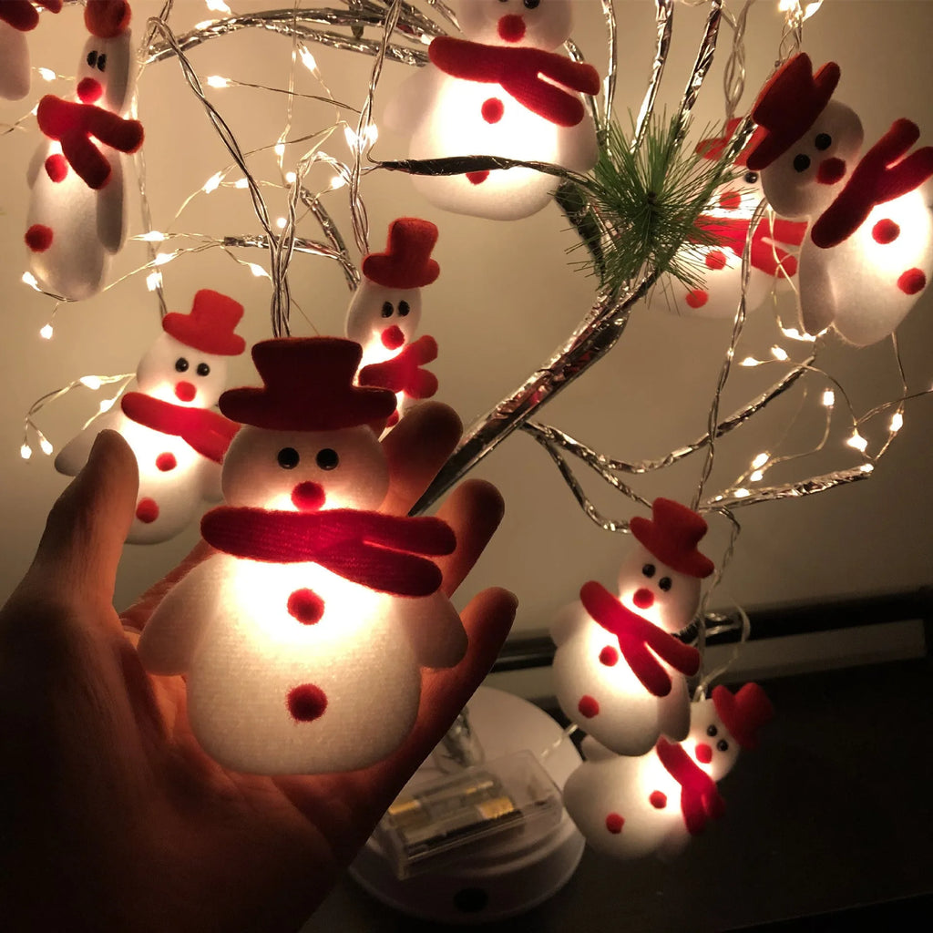 Christmas LED string lights with warm white glow showing snowman and elk deer themed lamps on a dark background