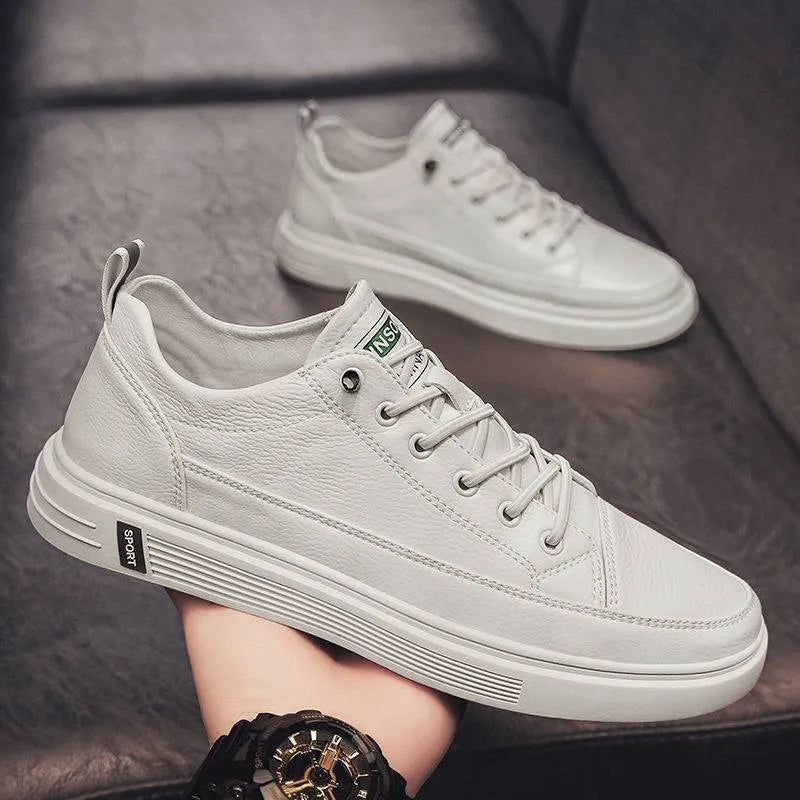 Men's white casual summer shoes with round toe and flat low heel on a plain background.