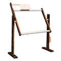 Height adjustable vertical desktop solid wood cross stitch frame in log colour small on a table