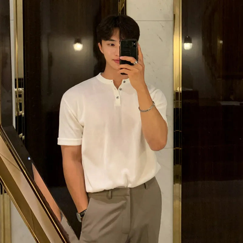 Man wearing a thin black slim-fit knitted short-sleeved shirt.