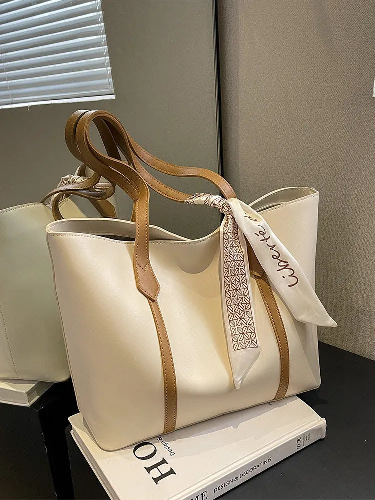 Women's large capacity soft tote bag with crossbody strap showing zipper compartment interior