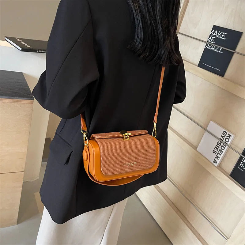 Women's PU leather messenger bag in horizontal square shape with contrast colour stitching and lock closure, available in multiple colours
