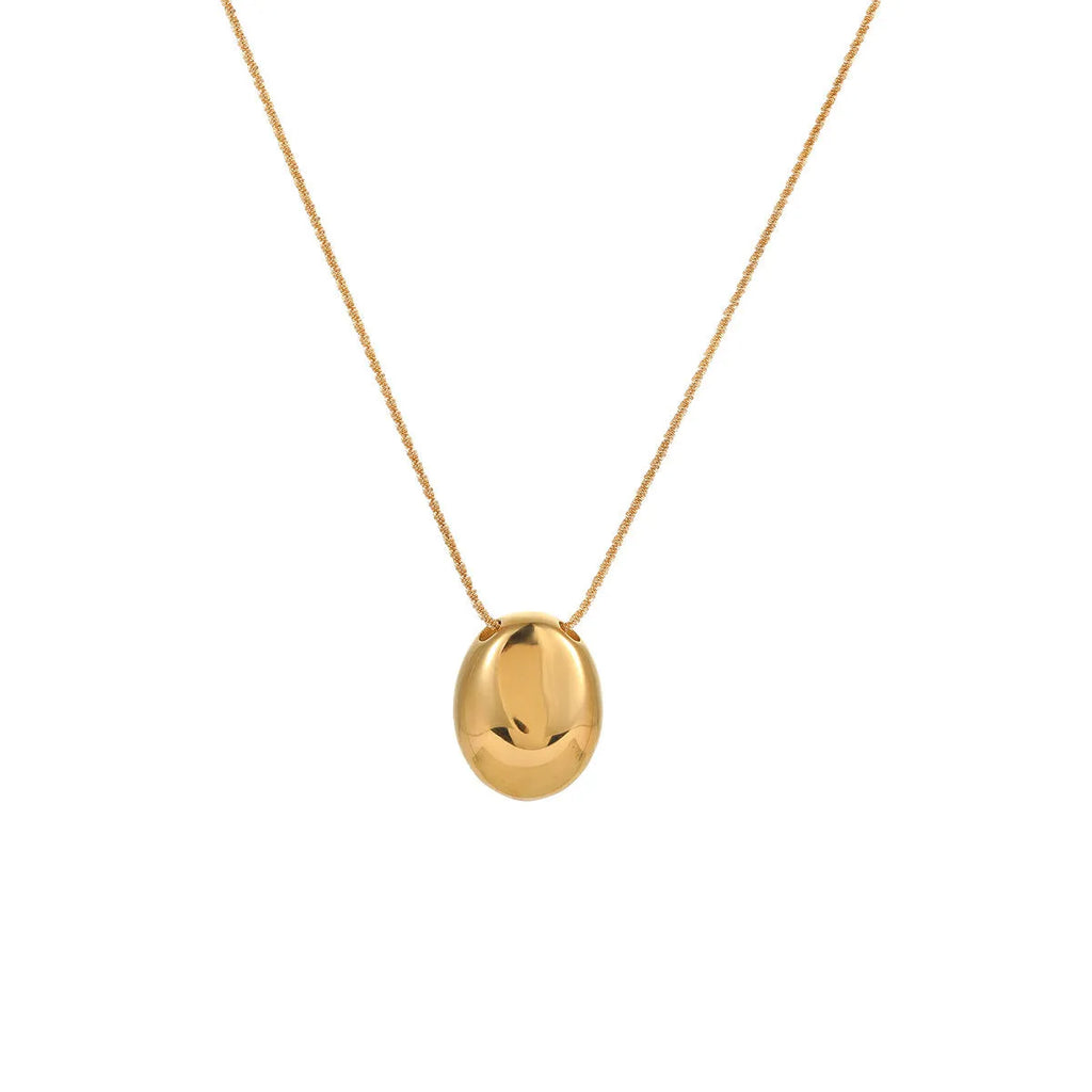 Gold geometric pendant on an adjustable stainless steel necklace chain.