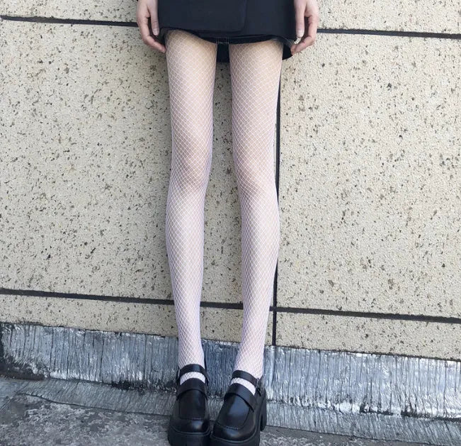 Women's sheer black and white mesh stockings showing large, medium, and small net patterns