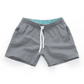 Man wearing soft polyester beach shorts in a straight-leg style, available in multiple colours and plus sizes.