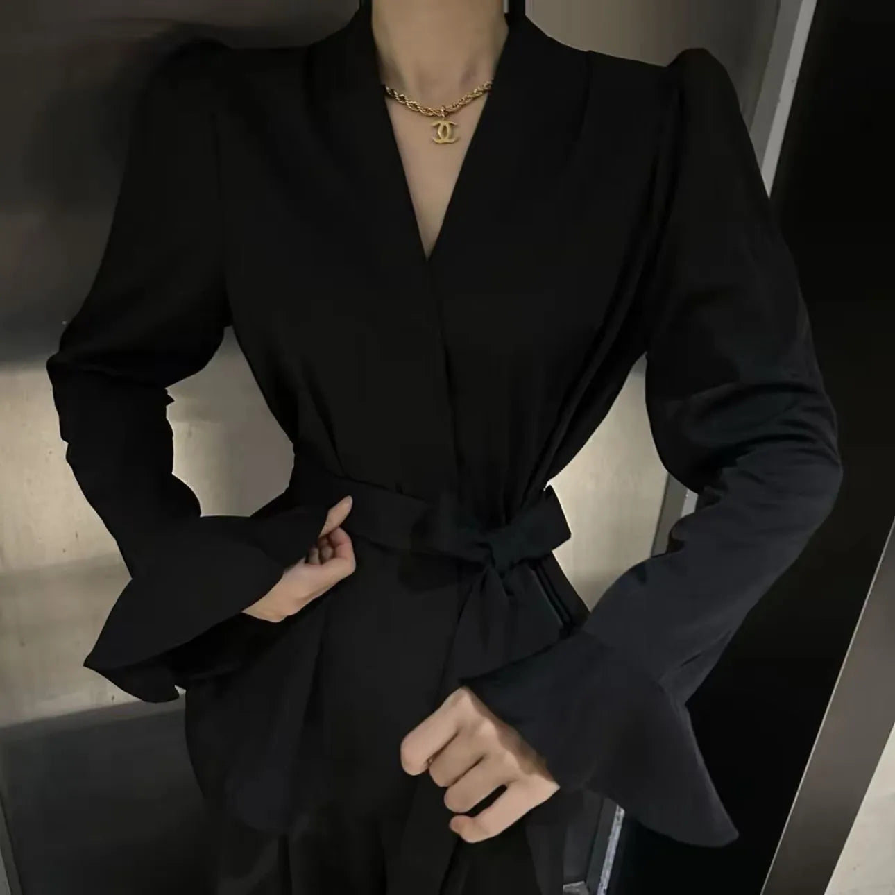 Women's French-style shirt with irregular collar, long bell sleeves, and tie-front closure in black colour