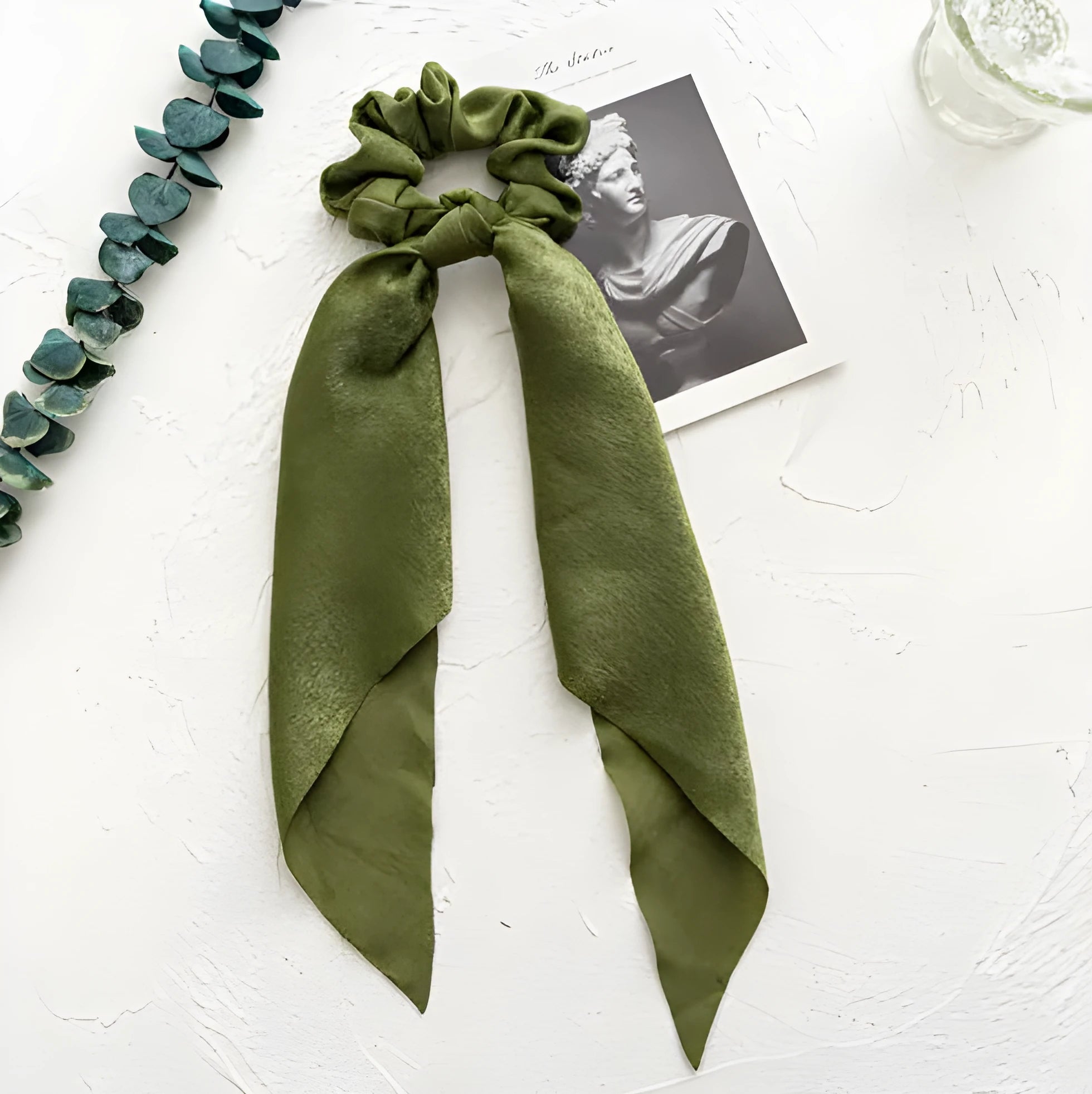 Long cloth ribbon women's hair accessory with floral ring detail in sage green.