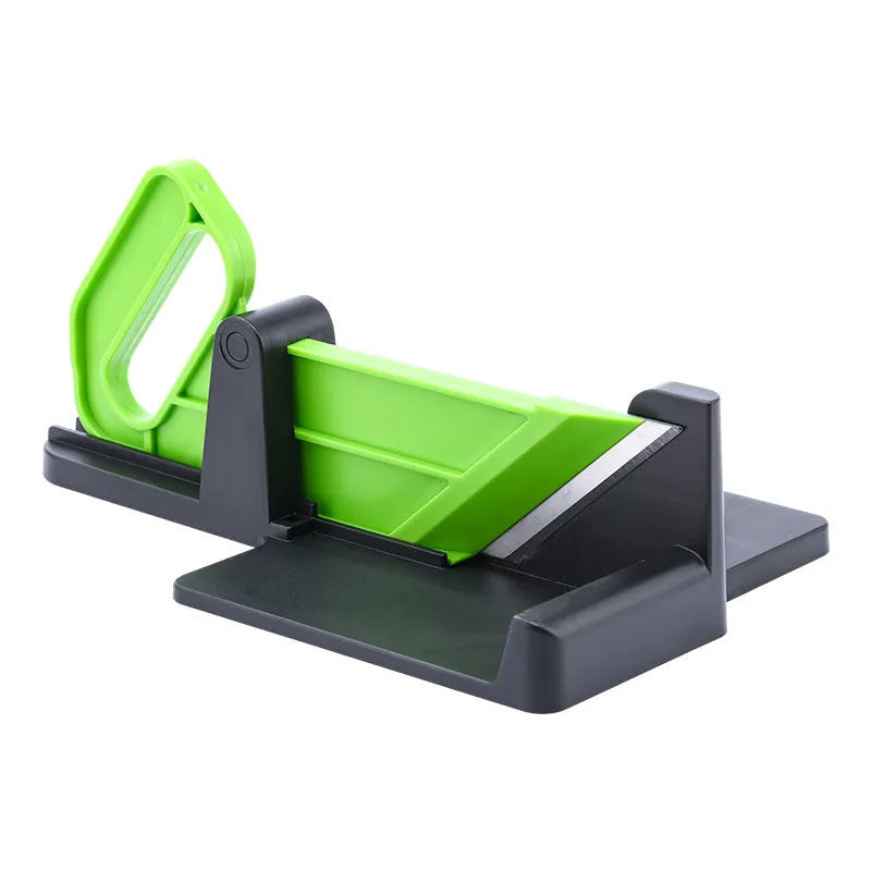 Green multifunctional vegetable cutter on a kitchen counter with stainless steel blade and plastic body