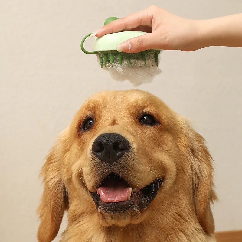 Soft silicone handheld pet hair remover and massage brush in dark blue on a white background.