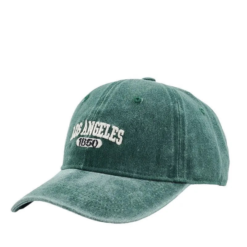 Adjustable peak cap with embroidered letters in distressed retro style, showing conical crown and 7cm brim