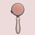 Green and pink two-sided silicone pet grooming brush with slicker brush and massage head.
