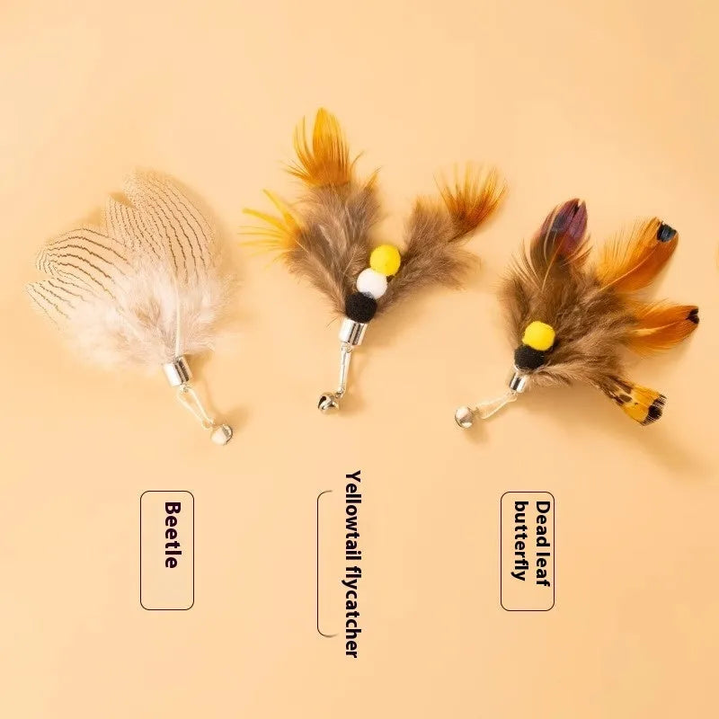 Three steel wire cat toy replacement heads with small flying insect designs on a white background