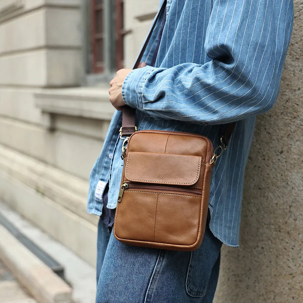 Men's brown genuine leather crossbody shoulder bag with sewing line detailing.