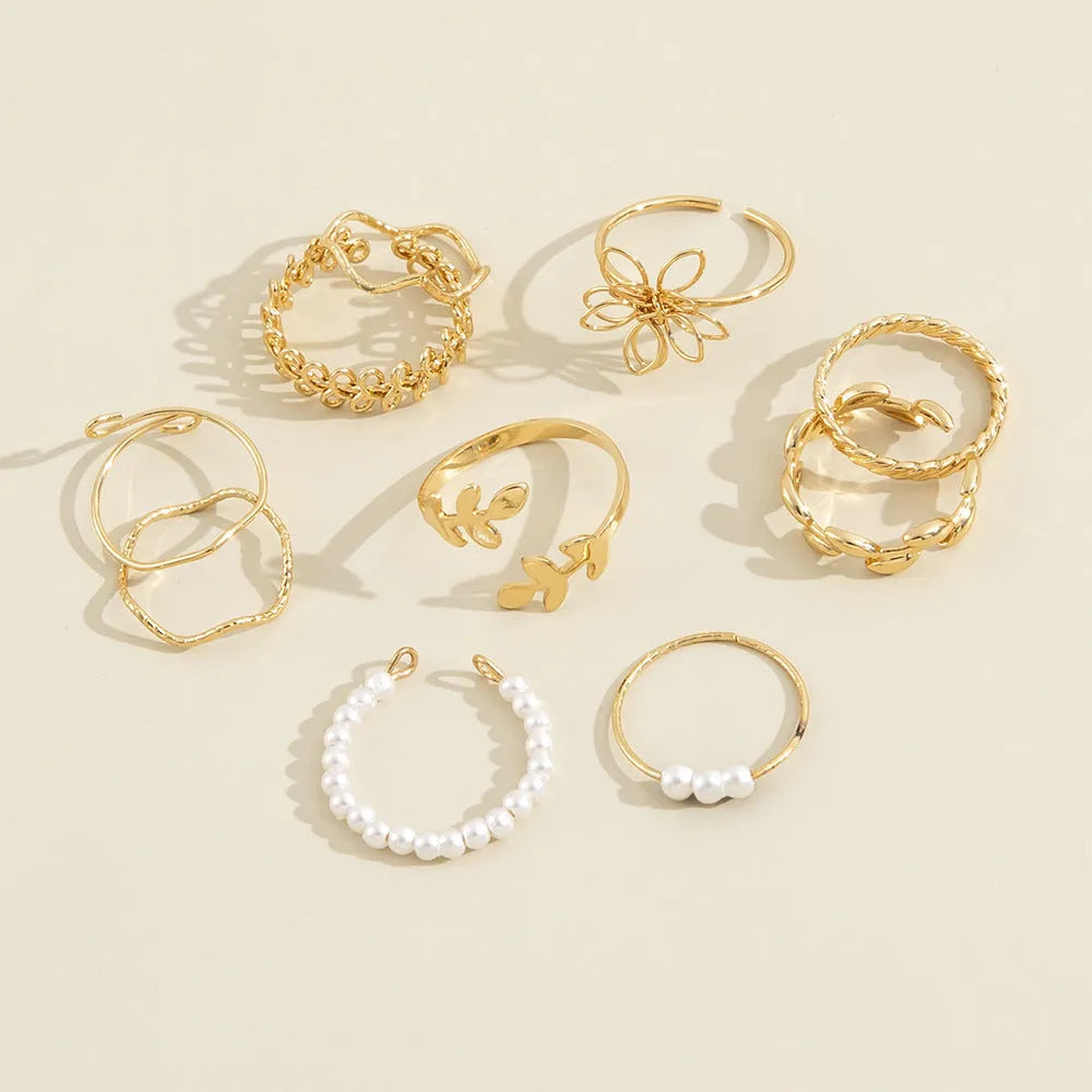 Gold-tone openwork floral ring with a glossy electroplated finish on an alloy band.