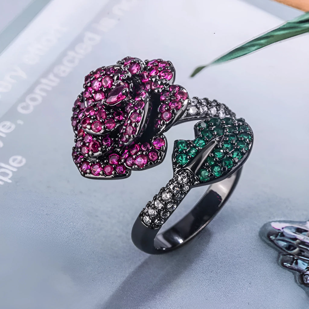 Women's black gold-plated geometric ring with red simulated corundum stones on a copper base.