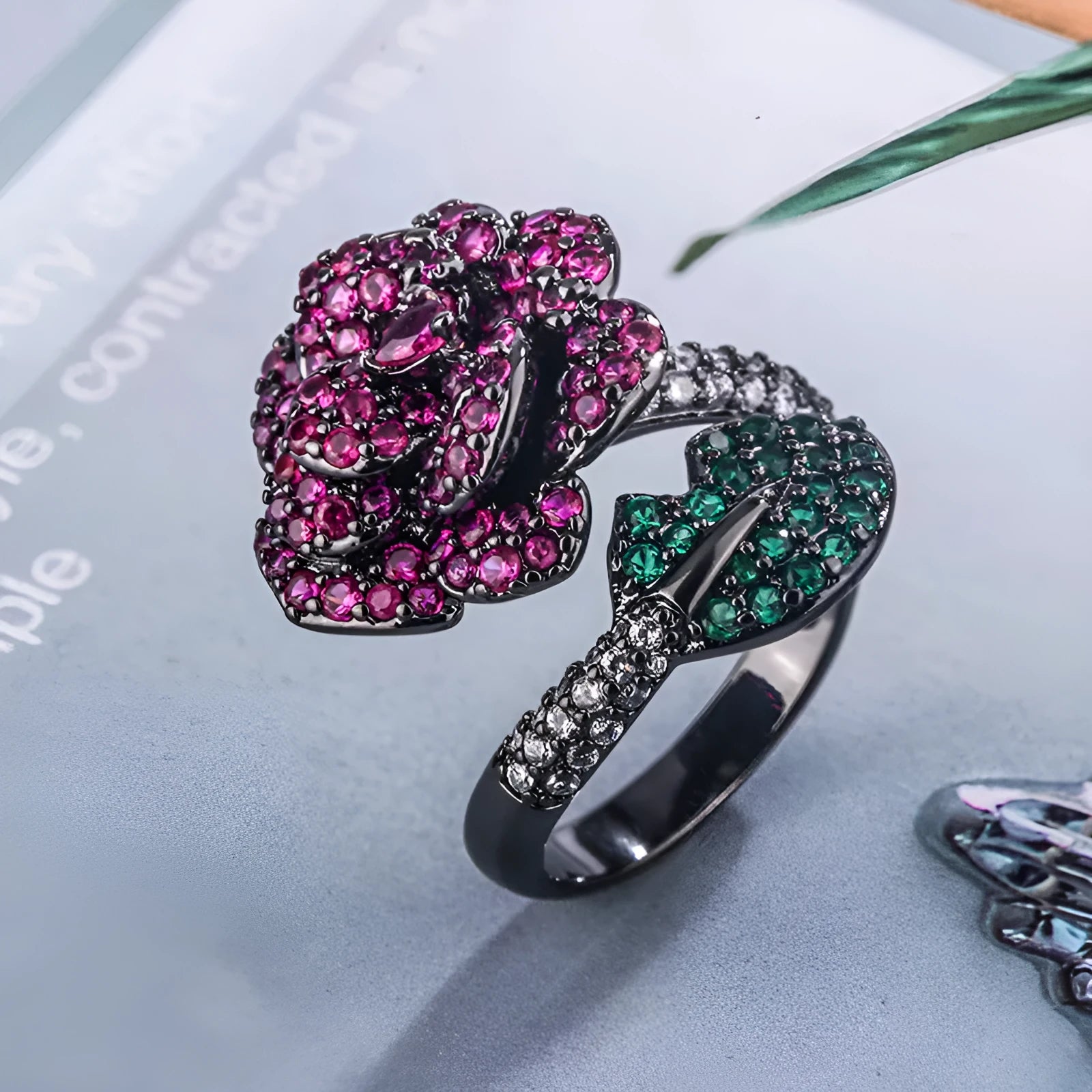 Women's black gold-plated geometric ring with red simulated corundum stones on a copper base.
