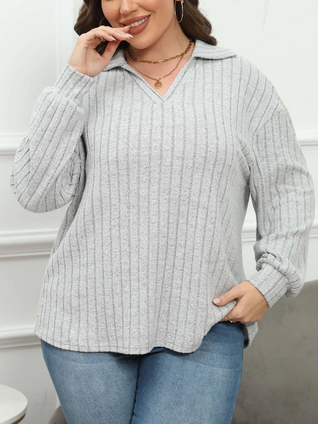Plus size women's gray fleece pullover with a polo collar and lantern sleeves on a hanger.