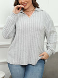 Plus size women's gray fleece pullover with a polo collar and lantern sleeves on a hanger.