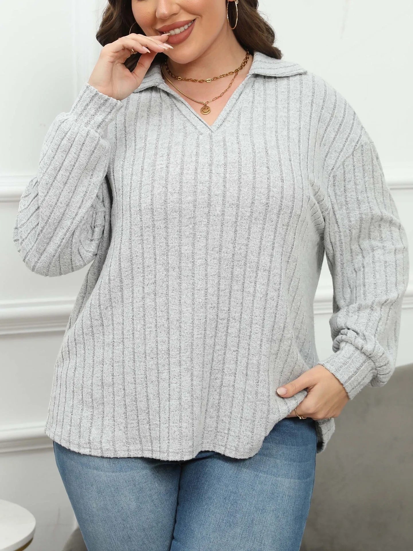 Plus size women's gray fleece pullover with a polo collar and lantern sleeves on a hanger.