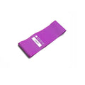 Four colour-coded resistance bands in purple, pink, blue, and grey with non-slip inner lines laid flat on a surface