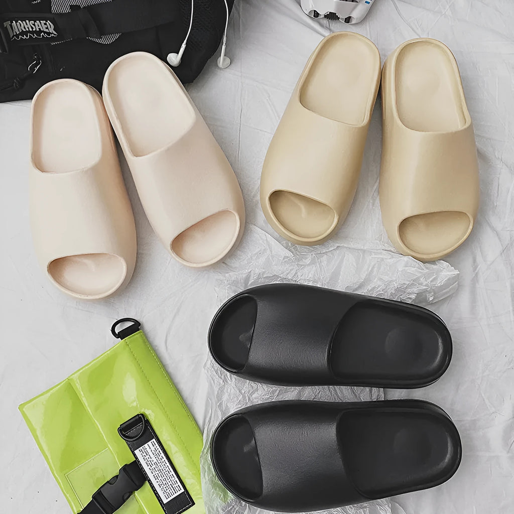 Women's beach slipper in green with a thick EVA sole, shown on a sandy background.