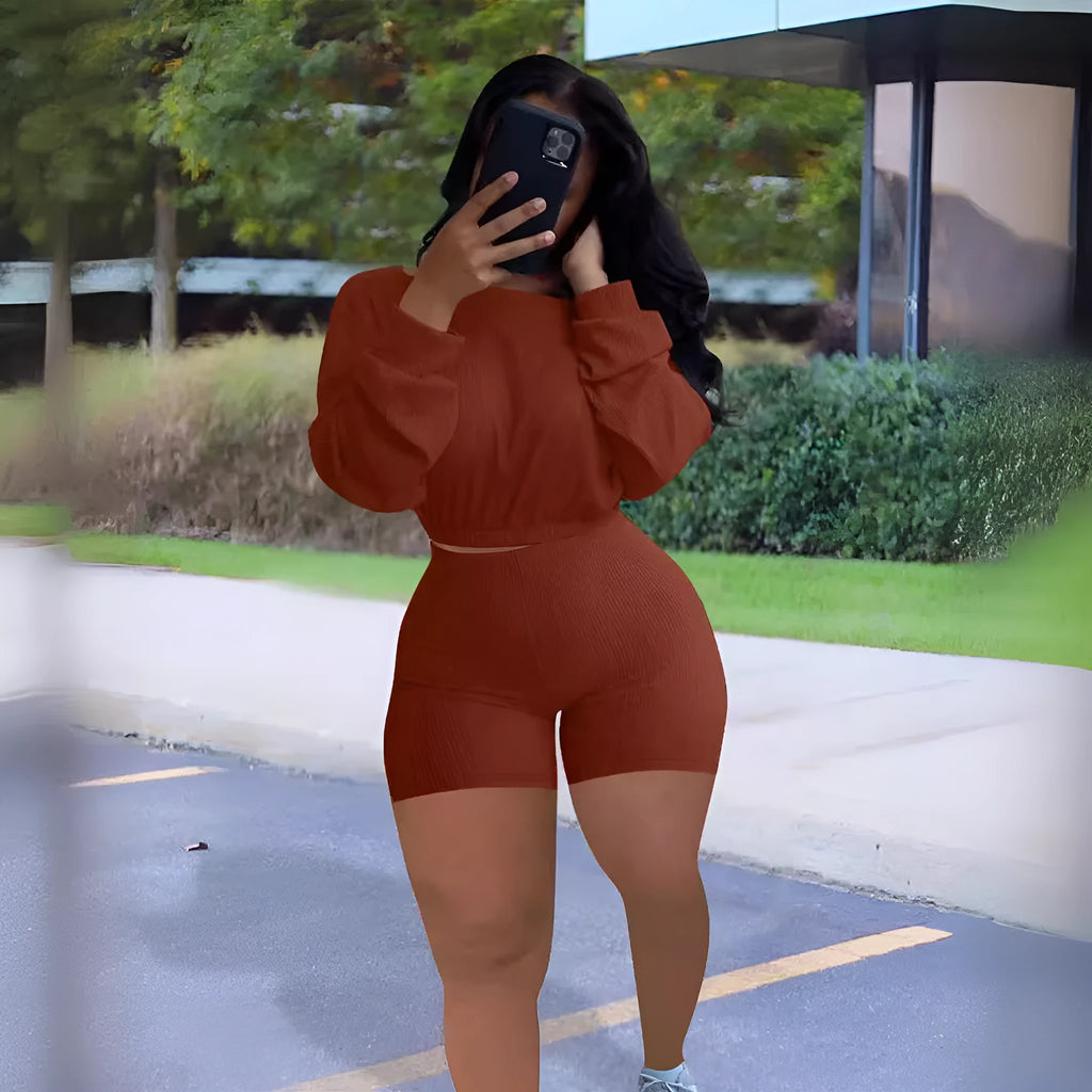 Women's off-the-shoulder long sleeve top and shorts two-piece set in a solid colour with a sunken stripe pattern.