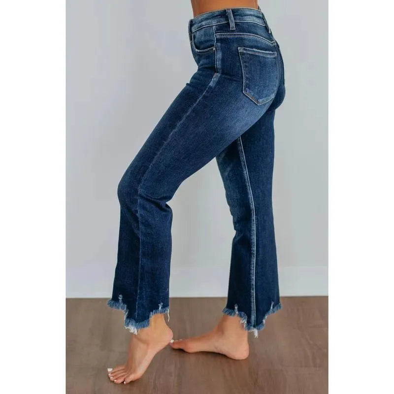 Women's solid colour denim jeans in dark blue and light blue, showing casual fit and hand-worn texture.