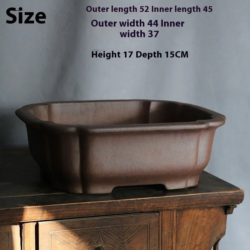 A modern rectangular flower pot made from purple sand ceramic, standing on a floor.