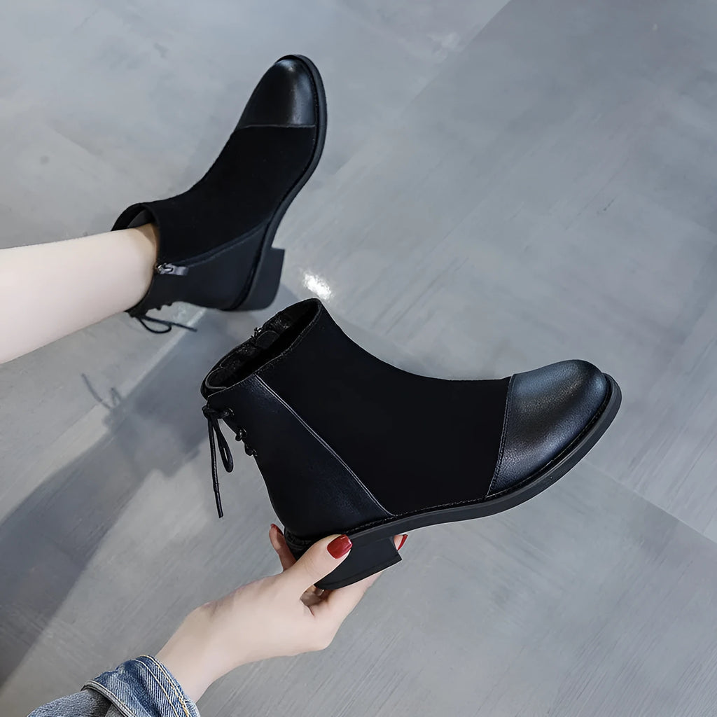 Black women's knee-high Martin boots with side zipper and round toe.