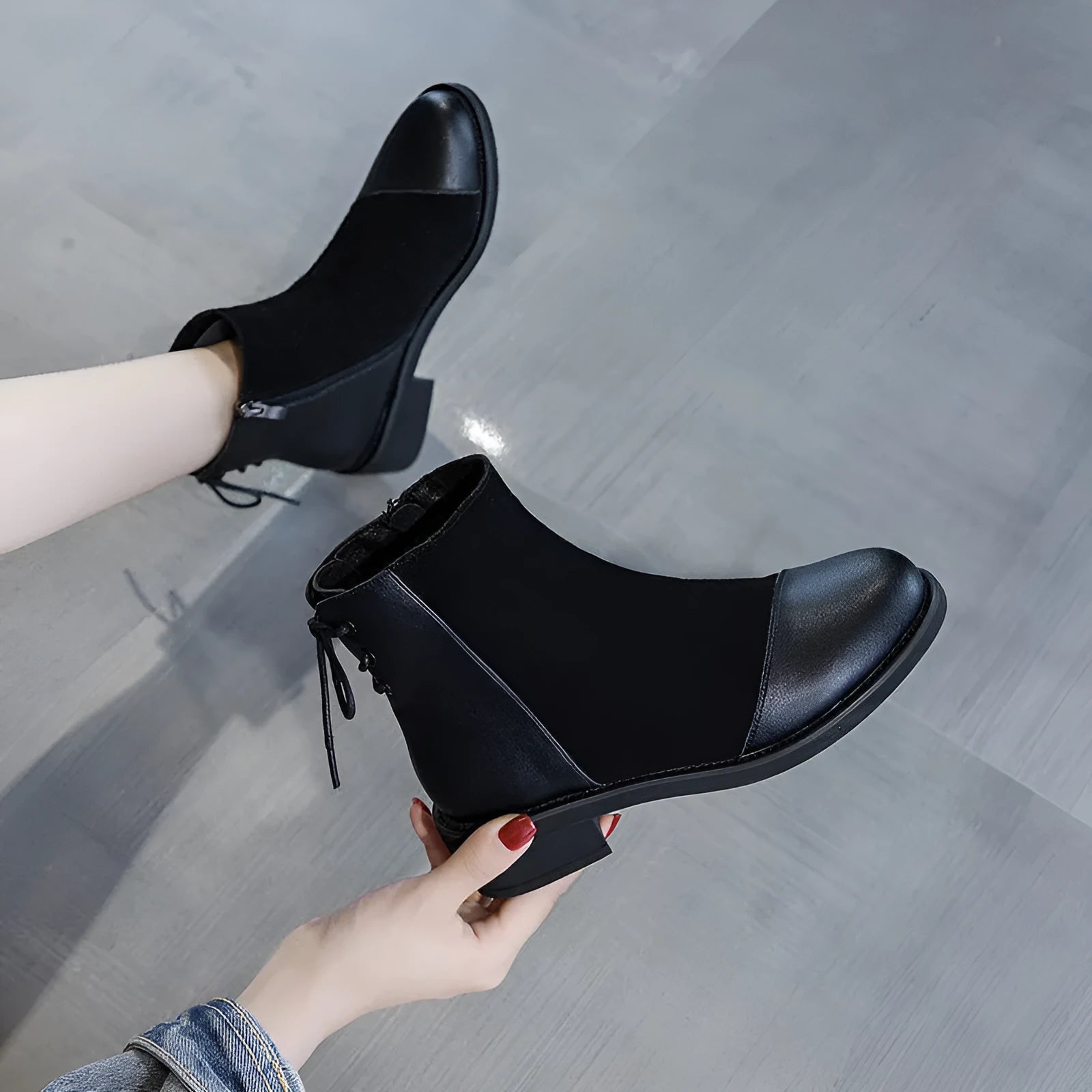 Black women's knee-high Martin boots with side zipper and round toe.