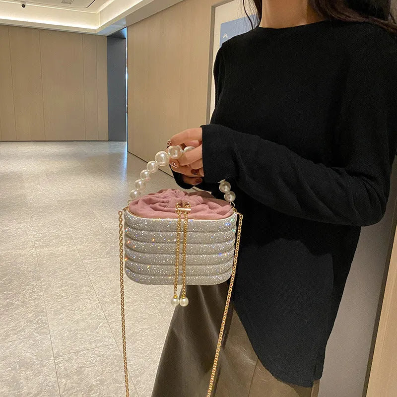Women's retro style crossbody bag with beaded pearl detail on soft PU material in rounded suitcase shape