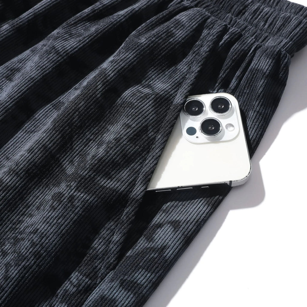 Men's black corduroy camouflage print athletic shorts with a high waist and straight-leg cut on a mannequin.