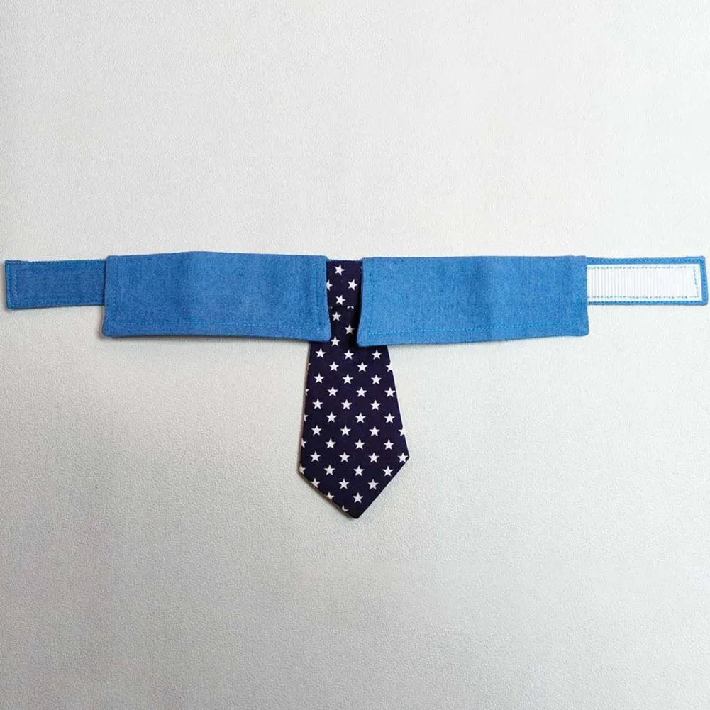 Denim pet collar with star pattern and bow tie on a table, adjustable fastener tape closure
